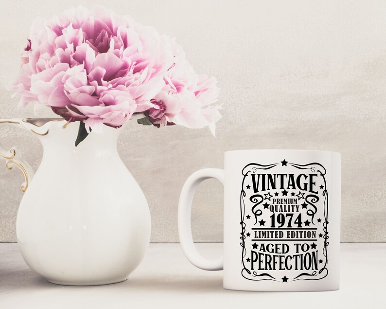 May include: White ceramic coffee mug with a black graphic that says "Vintage Premium Quality 1974 Limited Edition Aged to Perfection".