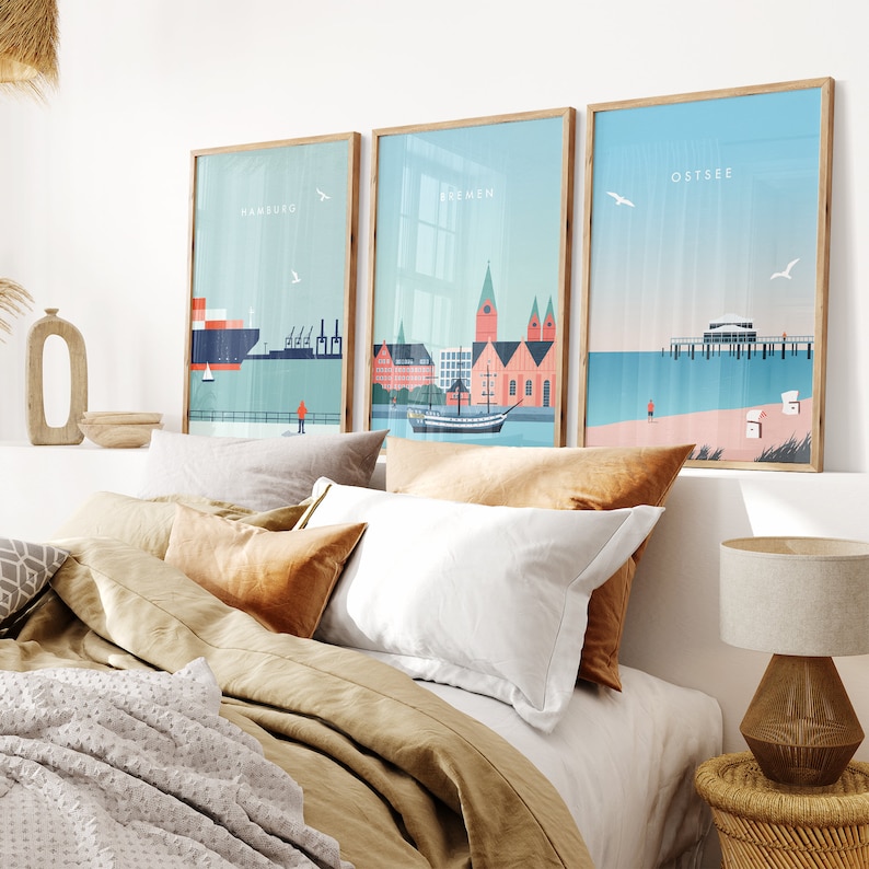 May include: Three framed illustrations of cityscapes with the words "Hamburg", "Bremen", and "Ostsee" printed on each. The illustrations are in a minimalist style with a blue and white color scheme.