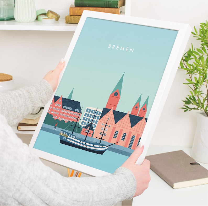 May include: A white framed print with a blue and green illustration of the Bremen skyline. The illustration features a ship, buildings, and the word "BREMEN" in white text.