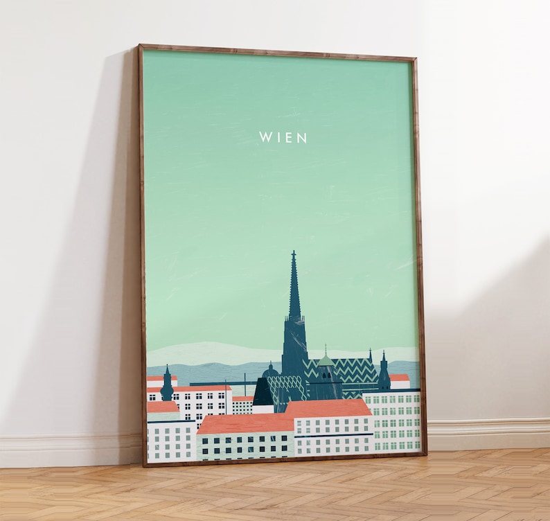 May include: A green and blue illustrated poster with the word "WIEN" at the top and a cityscape of Vienna, Austria. The poster is framed in a brown wood frame.