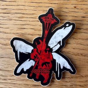 May include: A die-cut sticker featuring a red and black design with white accents. The design incorporates the Seattle Space Needle and the text "LINKIN PARK SEATTLE" and "EVERYONE TOGETHER".