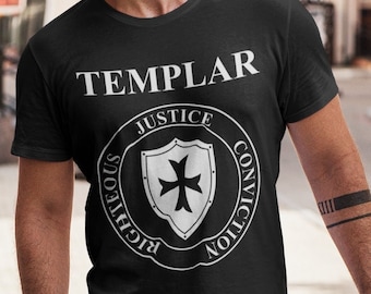 May include: Black t-shirt with the word "TEMPLAR" above a circular emblem featuring a cross and the words "JUSTICE", "CONVICTION", and "RIGHTEOUS". The shirt is paired with light blue ripped jeans and black sneakers.