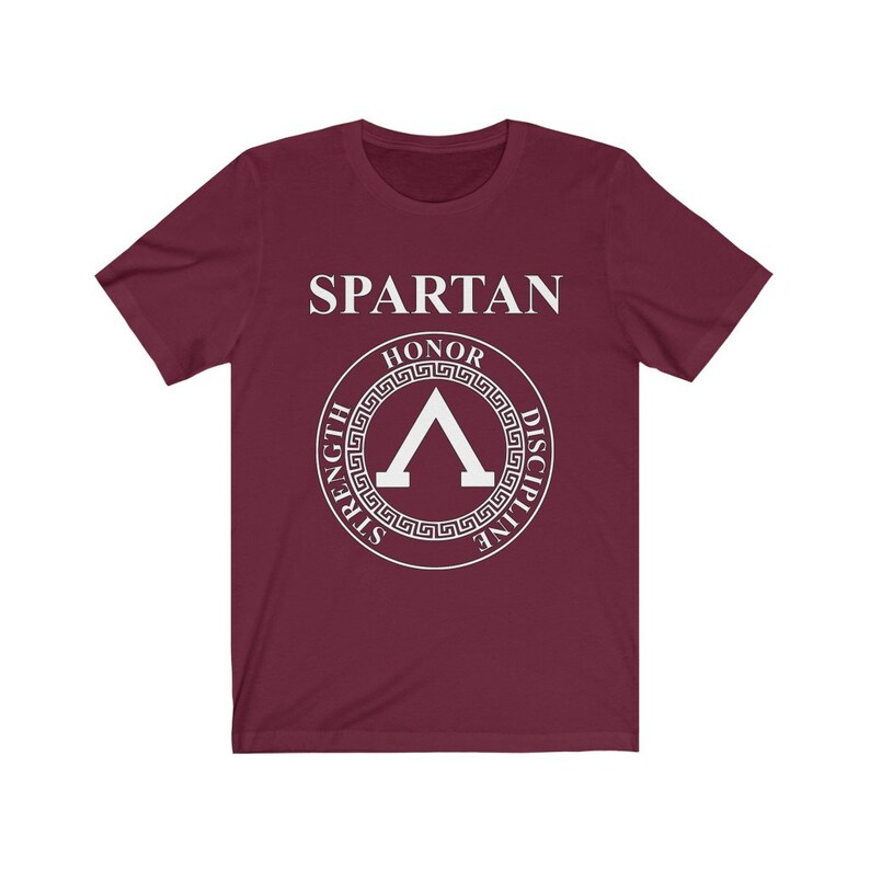 May include: A maroon t-shirt with a white graphic of a Spartan shield with the words "SPARTAN", "HONOR", "STRENGTH", "DISCIPLINE" around the shield.