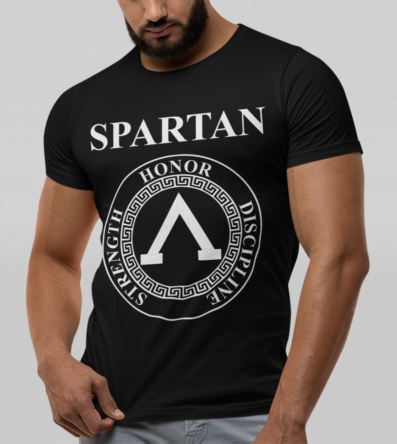 May include: Black t-shirt with a white graphic of a Spartan helmet with the words "Spartan", "Honor", "Strength", and "Discipline" around it.