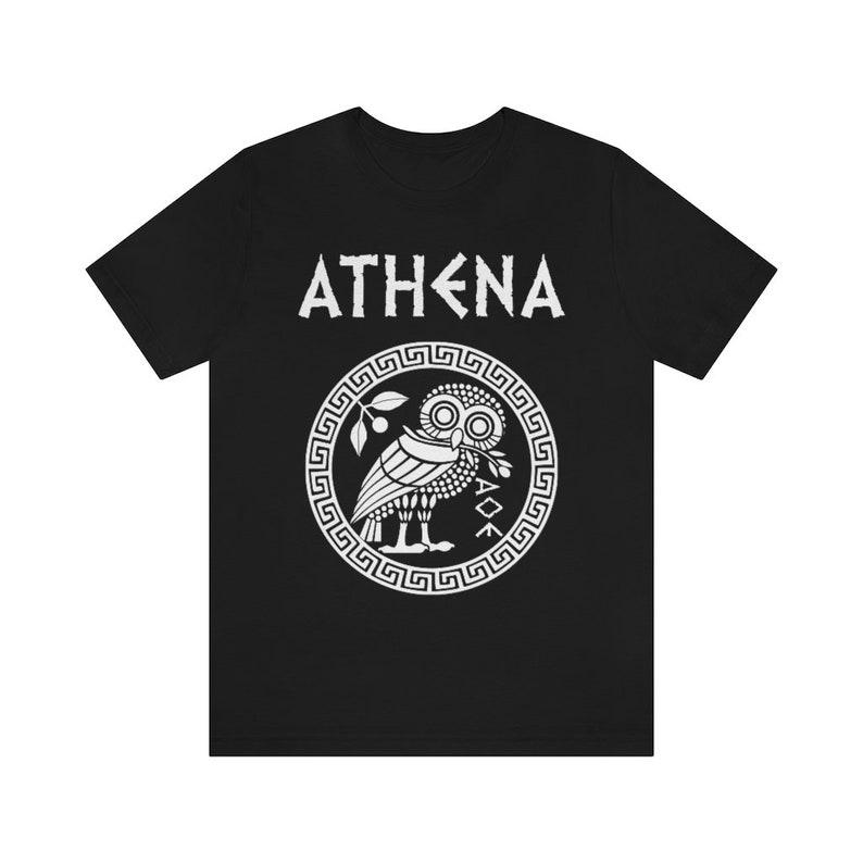 May include: Black t-shirt with a white graphic of the Greek goddess Athena's owl with the word "ATHENA" above it.
