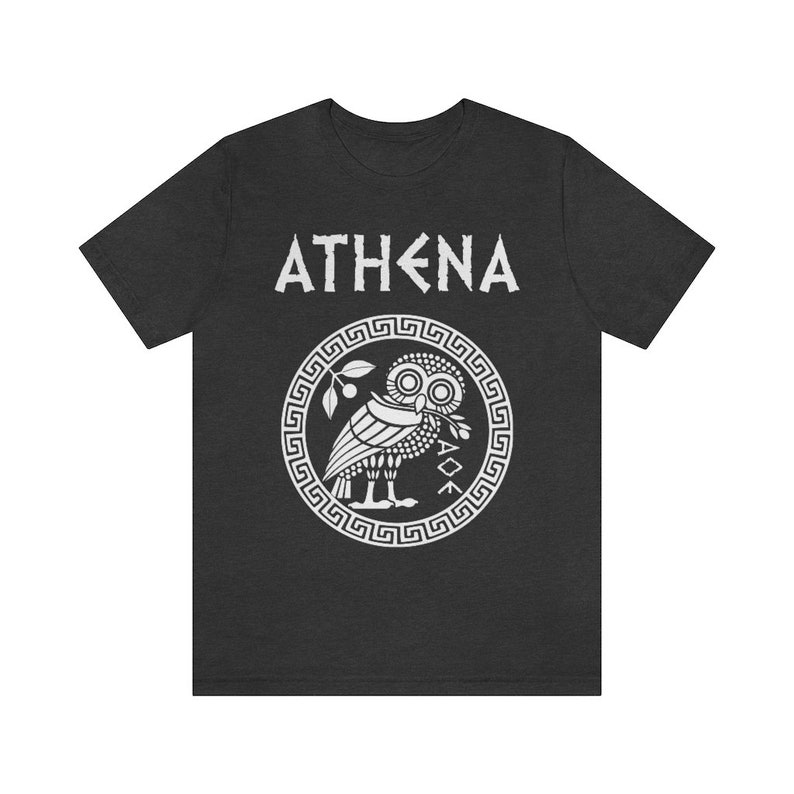 May include: A dark grey t-shirt with a white graphic of the Greek goddess Athena's owl and the word "ATHENA" in white.