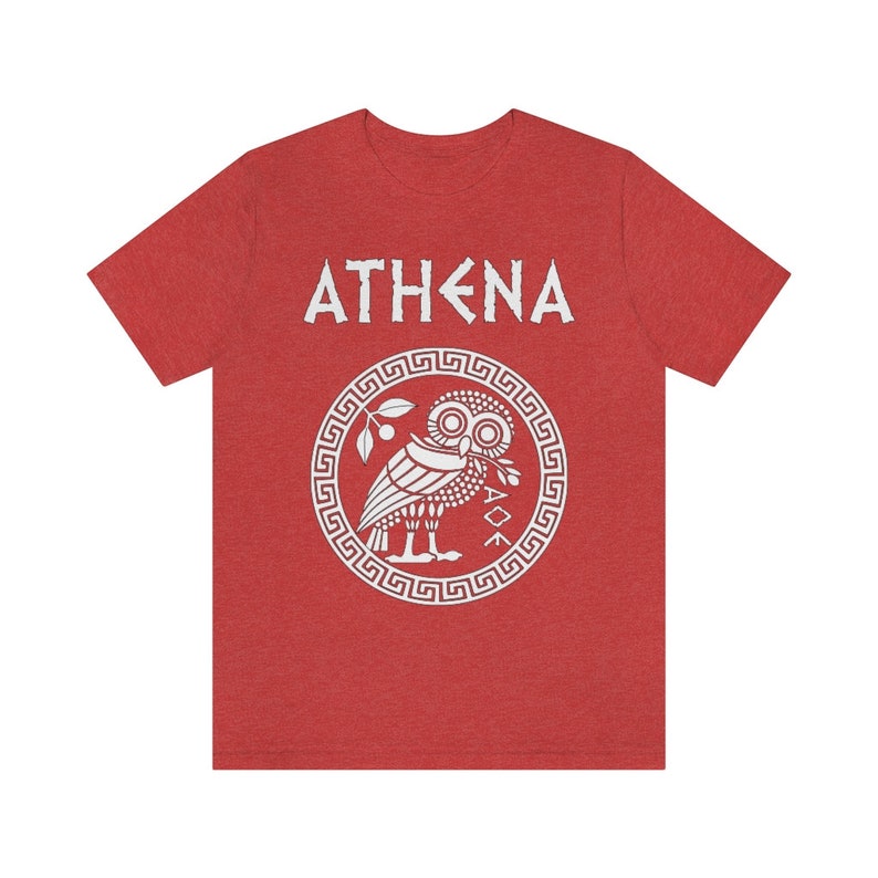 May include: Red t-shirt with a white graphic of the Greek goddess Athena's owl and the word "ATHENA" in white.