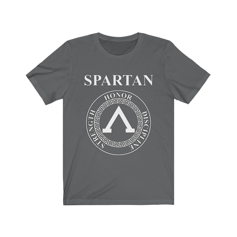 May include: A dark gray t-shirt with a white Spartan logo. The logo features a shield with the words "Honor, Strength, Discipline" surrounding it.