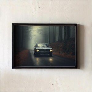 May include: Framed print of a vintage car driving on a wet road through a foggy forest. The car is a light blue-green color with its headlights on. The forest is dark with tall trees.