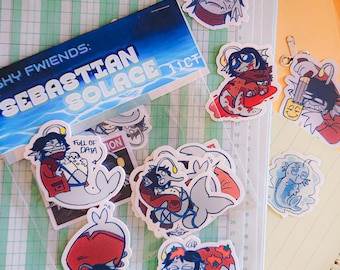 May include: A set of stickers featuring cartoon characters with fish tails. The stickers are in a clear plastic bag with a blue and white label that says "Shy Fwiends: Sebastian Solace 11CT". The stickers are on a green and white grid background.