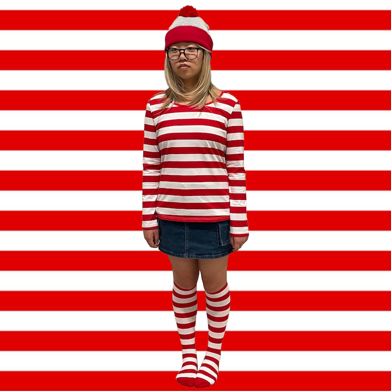 May include: A person wearing a red and white striped long-sleeved shirt, a red and white knit hat with a white pom-pom, a blue denim skirt, and red and white striped knee-high socks.