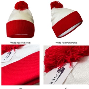 May include: White and red knit beanie with a red pom pom on top. The beanie has a white band around the bottom and a red band around the top.