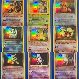 May include: A collection of nine holographic Pokemon trading cards featuring various Pokemon characters, including Blastoise, Charizard, Dragonite, Arcanine, and Mewtwo. The cards are in excellent condition and have a vibrant rainbow foil finish.