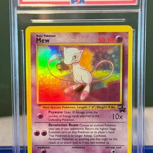 May include: A graded Pokémon card featuring Mew from the 2000 Pokémon Promo Black Star series. The card is encased in a protective case and has a GEM MT 10 grade. The card measures 1 foot 4 inches in length and weighs 9 pounds.