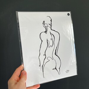 May include: A black and white line drawing of a person's back, hips, and shoulders.