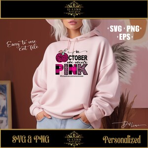 May include: Pink and black graphic design with a pink apple and the text "In October we wear pink" and the hashtag "#breastcancerawareness".