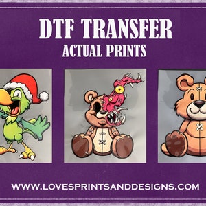 May include: Three DTF transfers, one with a green parrot wearing a Santa hat, one with a teddy bear with a monster face, and one with a brown teddy bear. The transfers are on a purple background with the text "DTF TRANSFER ACTUAL PRINTS" and "WWW.LOVESPRINTSANDDESIGNS.COM".