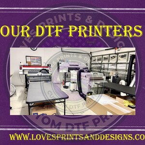 May include: A workshop with two large white DTF printers, a table with boxes, and a sign that reads "Our DTF Printers" in yellow letters. The sign is on a purple background with a white border. The website address "www.lovesprintsanddesigns.com" is at the bottom of the image.