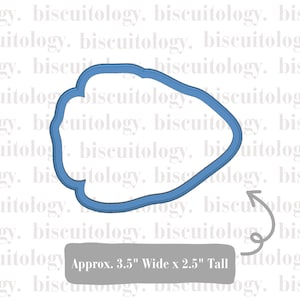 May include: A blue cookie cutter shaped like a seashell with a white outline. The cutter is approximately 3.5 inches wide and 2.5 inches tall. The text "Approx. 3.5" Wide x 2.5" Tall" is written in white on a gray background.