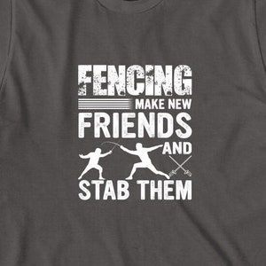 May include: Dark gray t-shirt with a white graphic of two fencers and the text "Fencing Make New Friends And Stab Them".