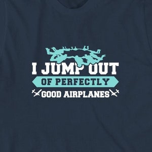 May include: A navy blue t-shirt with a sky blue graphic of skydivers and the text "I JUMP OUT OF PERFECTLY GOOD AIRPLANES".