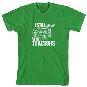 May include: Green t-shirt with a white tractor graphic and the text "I Still Play With Tractors".