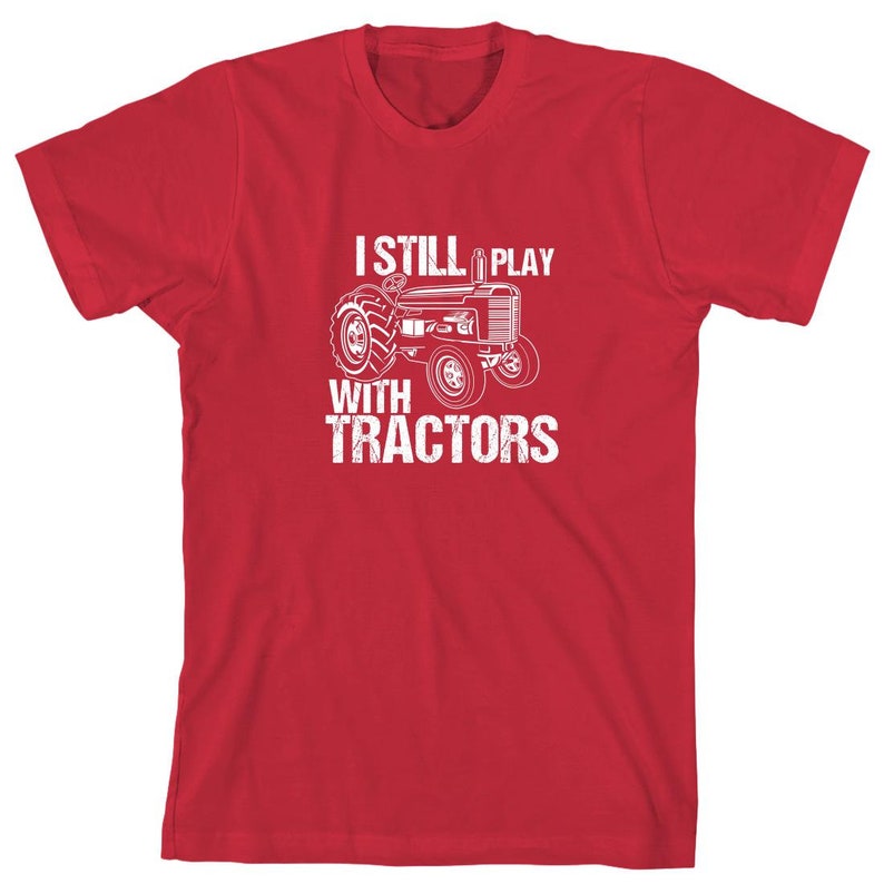 May include: Red t-shirt with a white graphic of a tractor and the text "I Still Play With Tractors".
