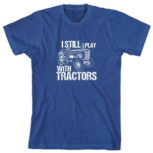 May include: A royal blue t-shirt with a white graphic of a tractor and the text "I still play with tractors".