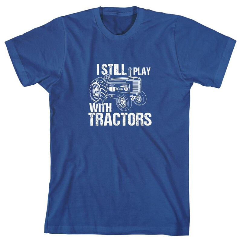 May include: A royal blue t-shirt with a white graphic of a tractor and the text "I still play with tractors".