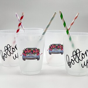 May include: Frosted plastic cups with the words "bottoms up" and a car graphic with a floral arrangement and the word "divorced". The cups have striped straws in them. A fun party favor for a divorce celebration.
