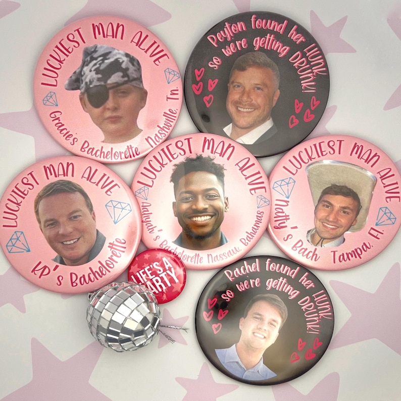 May include: Six pink and black round buttons with a white border. Each button features a different man's face and text. The text on the buttons includes "Luckiest Man Alive", "Gracie's Bachelorette", "Nashville, TN", "Peyton found her HUNK", "so were getting DRUNK", "Aahyah's Bachelorette", "Nassau, Bahamas", "Natty's Bach", "Tampa, FL", "Rachel found her HUNK", "so were getting DRUNK", "KP's Bachelorette", "Life's a Party".