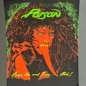 May include: Black iron-on patch with a green and orange image of a monster with the text "Poison" and "Open Up and Say... Ahh!"