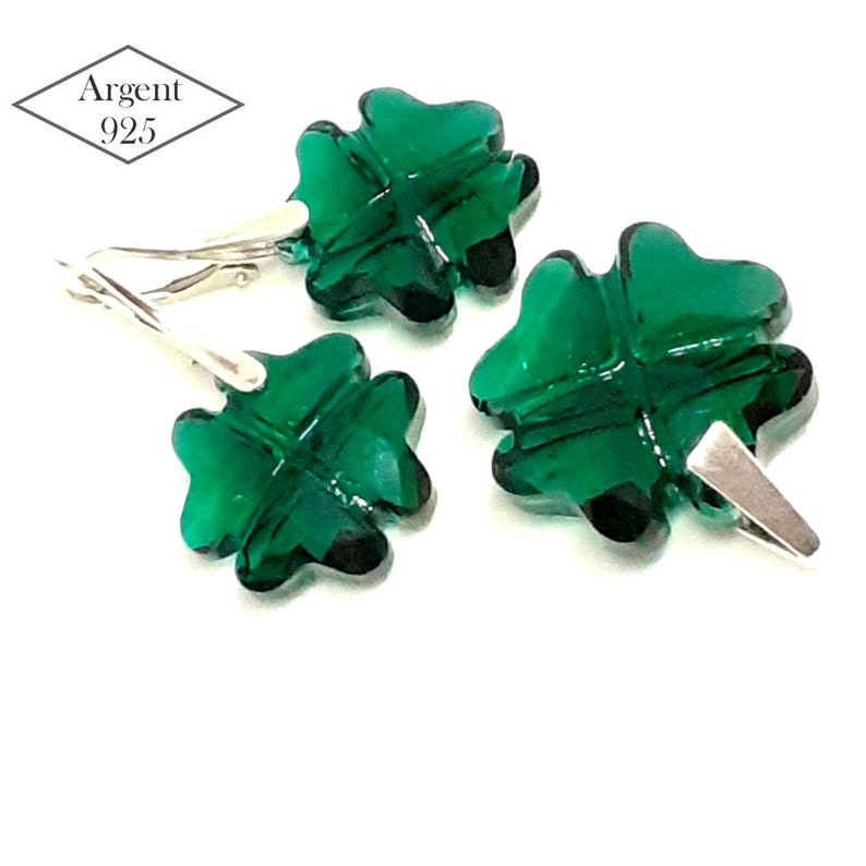 May include: A set of three silver earrings featuring a four-leaf clover design with green crystal accents. The earrings are marked "Argent 925".