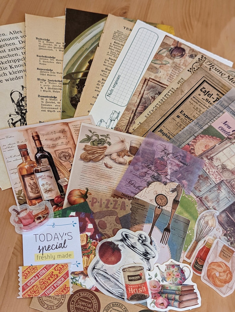 May include: A collection of vintage-style paper ephemera with a variety of designs, including a pizza slice, a jar of hash, a teapot, and a fork and knife. The papers are in shades of brown, cream, and white, with some featuring text and illustrations. The papers are arranged in a random pattern on a wooden surface.