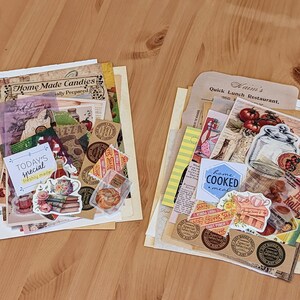 May include: A collection of vintage paper ephemera with images of food, including pizza, hot rolls, and a jar of pickles. The paper ephemera is arranged on a wooden surface. The text on the paper ephemera includes "Home Made Candies", "Today's Special", "Freshly Made", "Waim's Quick Lunch Restaurant", "Home Cooked Meal", and "Hot Rolls".