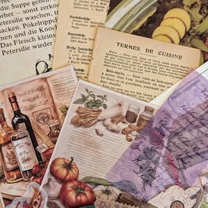 May include: A collection of vintage recipe cards and paper ephemera with a theme of food and cooking. The cards feature illustrations of vegetables, spices, and a bottle of wine. The text on the cards includes the words "Butterlohe", "Sardellenfose", "Kapernjose", "Wei&szlig;e Zwiebelso&szlig;e", and "TERMES DE CUISINE".