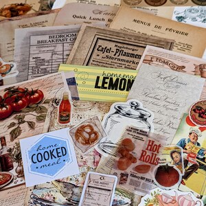 May include: A collection of vintage paper ephemera with a variety of designs and text, including a menu, a recipe, and a sign for homemade lemonade. The papers are arranged on a wooden surface and include images of food, drinks, and other objects.