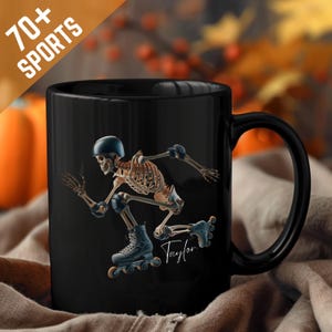 May include: Black ceramic mug featuring a skeleton rollerblading, wearing a helmet and pads. The mug has the text "70+ SPORTS" and the name "Taylor" in a script font.