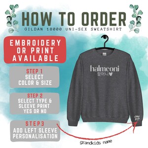 May include: A gray Gildan 18000 unisex sweatshirt with the text "halmeoni 할머니&hearts;" printed on the front. The sweatshirt has a red arrow pointing to the left sleeve, where the text "chloe josh" is printed. The text "grandkids name" is printed below the sweatshirt.