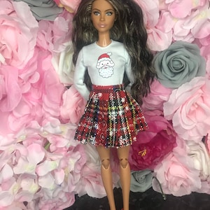 Christmas dolls top with Father Christmas on it and tartan pleated skirt with snowflakes and red shoes