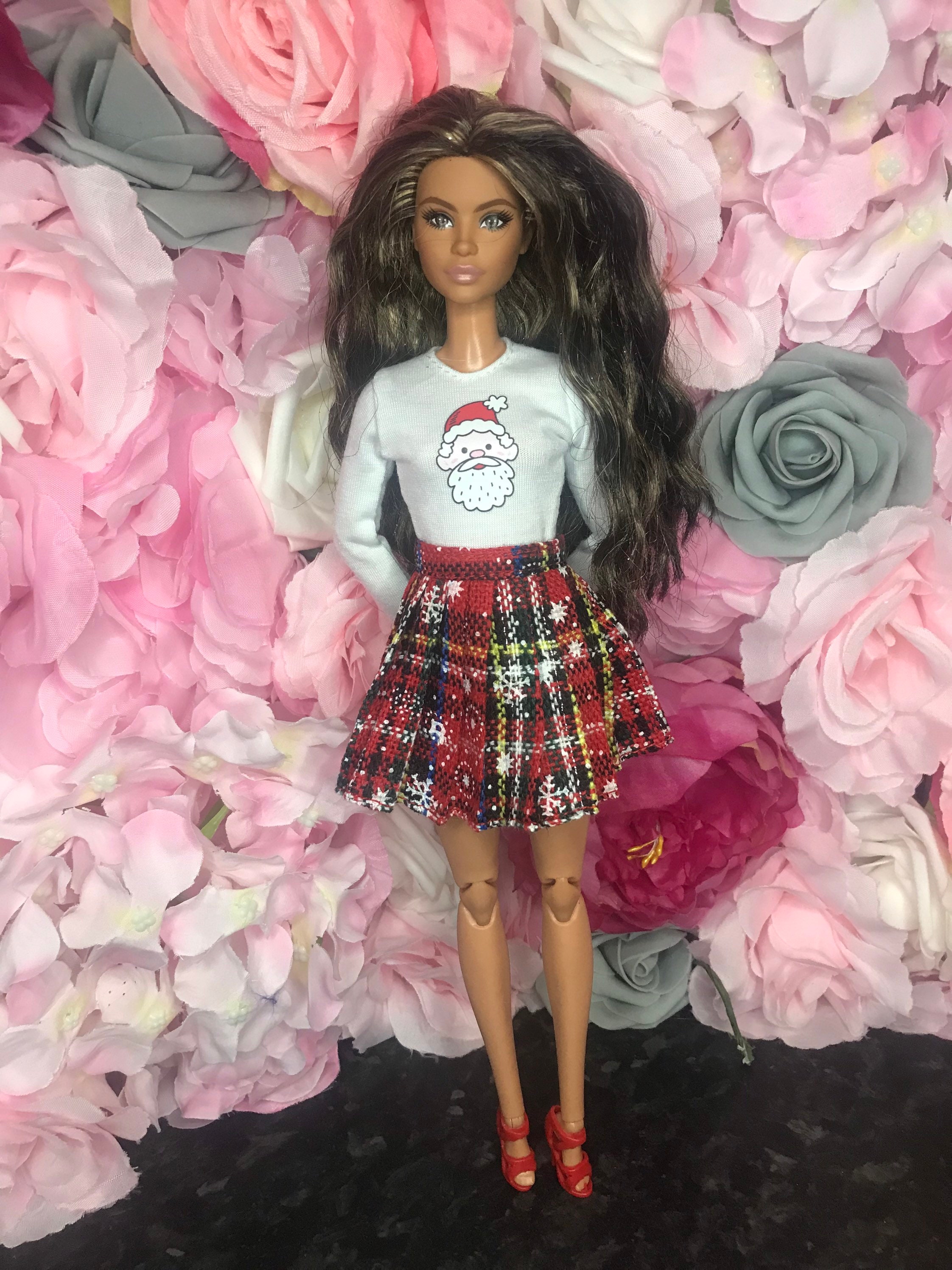 Christmas dolls top with Father Christmas on it and tartan pleated skirt with snowflakes and red shoes