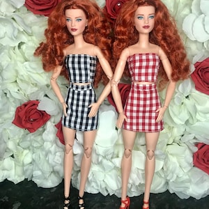 7pc dolls bundle. 2 crop tops 2 skirts and 3 pairs of shoes.