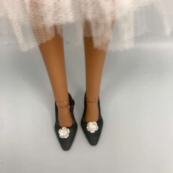 1 pair of black dolls shoes with a white camellia flower Embellishment