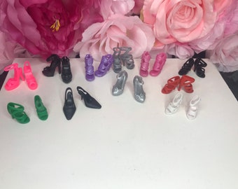 11 pair of dolls shoes. All different colours. Dolls footwear collection