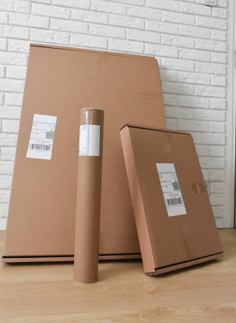 May include: Three brown cardboard boxes, one is a tube, and two are rectangular. The boxes are all sealed with tape and have shipping labels on them.