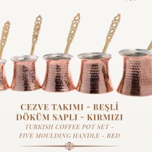 May include: Set of five copper Turkish coffee pots with handles and spoons. The pots are red and have a hammered finish. The text on the image reads "CEZVE TAKIMI - BEŞLİ DÖKÜM SAPLI - KIRMIZI TURKISH COFFEE POT SET - FIVE MOULDING HANDLE - RED"