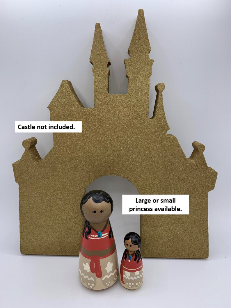 May include: Two wooden dolls dressed as a Disney princess, one large and one small, standing in front of a gold glitter castle cutout. "Large or small princess available." is written on the cutout. "Castle not included." is written at the top of the cutout.