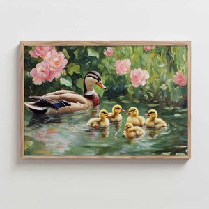 May include: A framed painting shows a duck and its ducklings in a pond. The ducklings are yellow, and the adult duck has brown, white, and blue feathers. Pink roses and green foliage surround the pond, creating a tranquil, natural scene.
