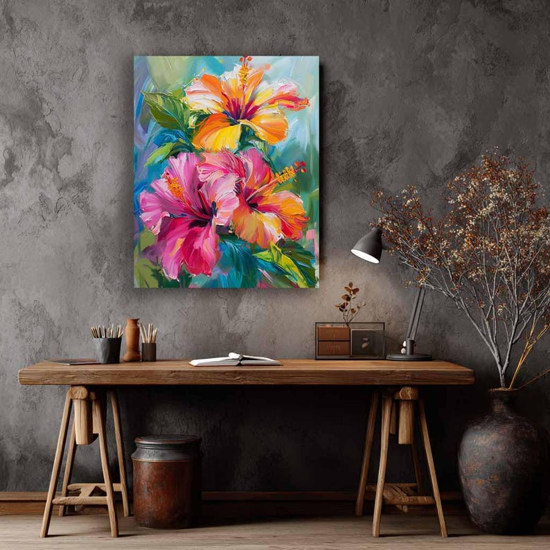 May include: A vibrant floral painting featuring two hibiscus flowers in shades of orange and pink, set against a backdrop of green and blue. The artwork is displayed on a gray wall, above a wooden desk.