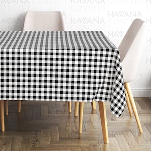 May include: Black and white checkered tablecloth on a wooden table with two chairs. The tablecloth has a classic gingham pattern.